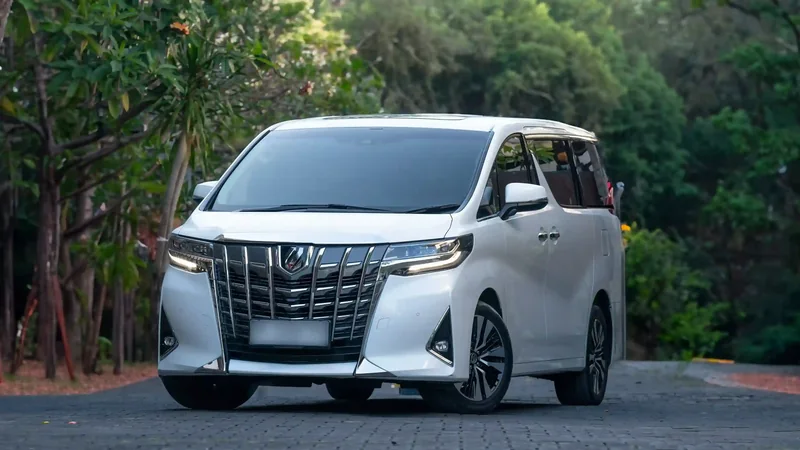 White Toyota Alphard on a paved drive, front three-quarter view