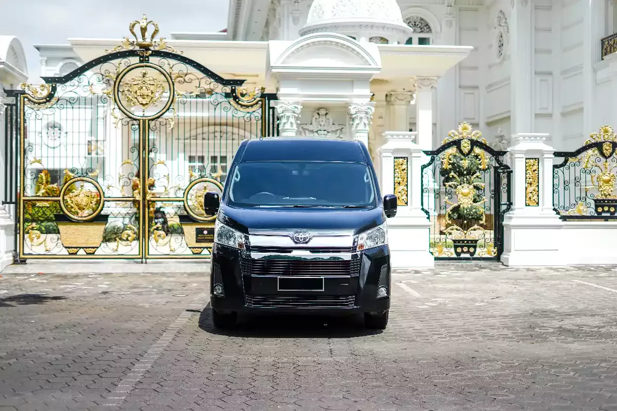 Black Toyota Hiace Premio photographed head-on at an ornate gate