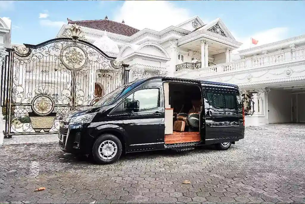 Black Toyota Hiace with its side door open and the cabin steps down
