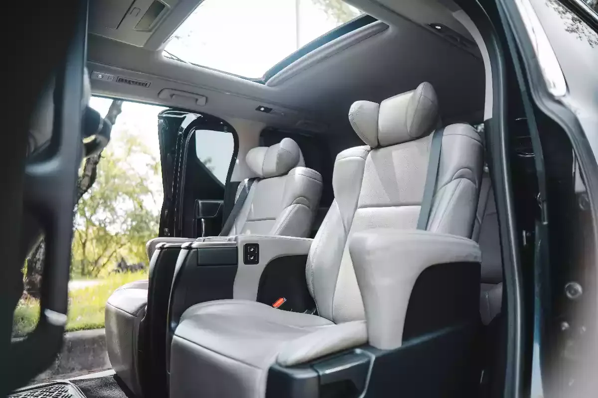 Grey leather captain seats with ottoman leg rests inside a Toyota Vellfire
