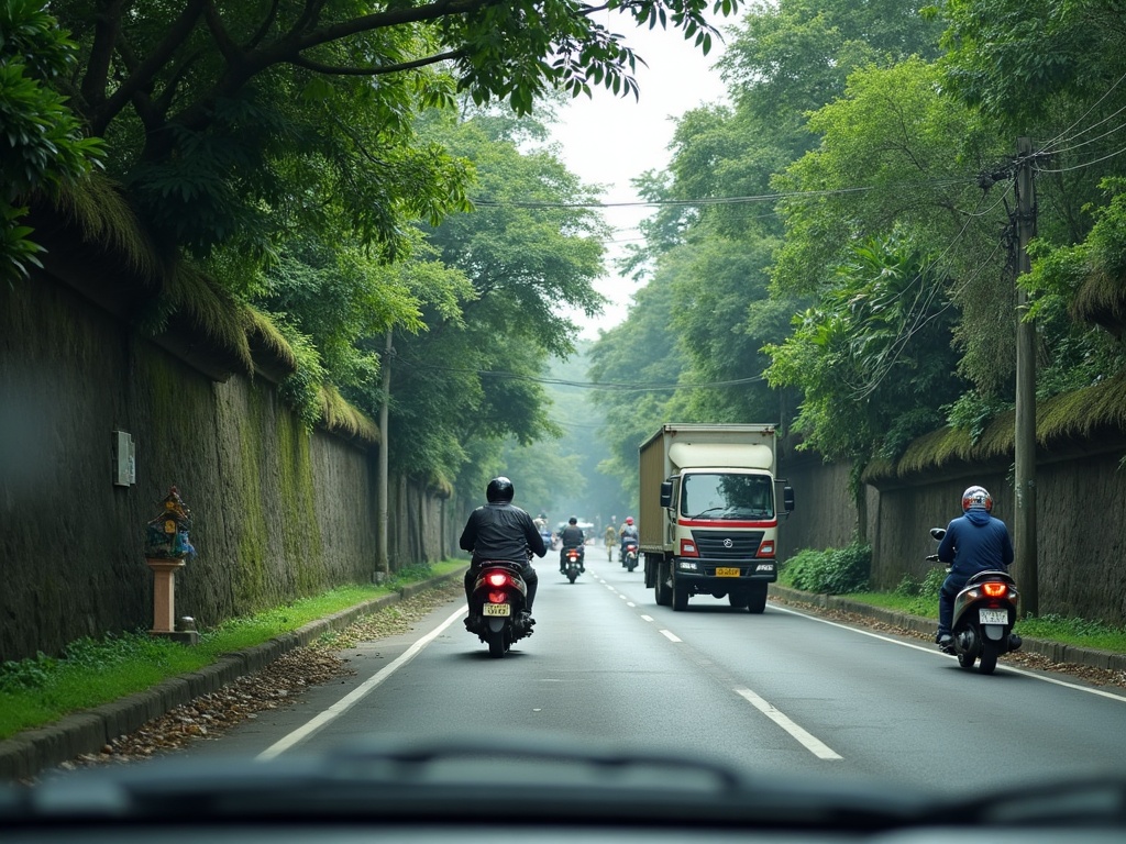 Narrow Bali road crowded with scooters beside a carved stone wall, seen from inside a slow-moving chauffeured car